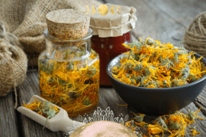 Photo of herbs in a bowl and also in a glass jar